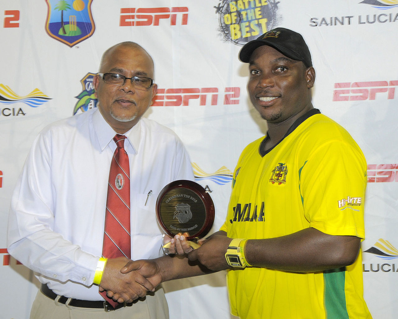 Trinidad & Tobago Cricket Board president Azim Bassarath presents an award to Tamar Lambert, January 9, 2013