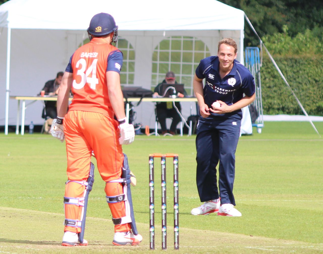 Josh Davey fields in his follow through to keep Wesley Barresi in his crease, Netherlands v Scotland, WCL Championship, Amstelveen, September 14, 2015