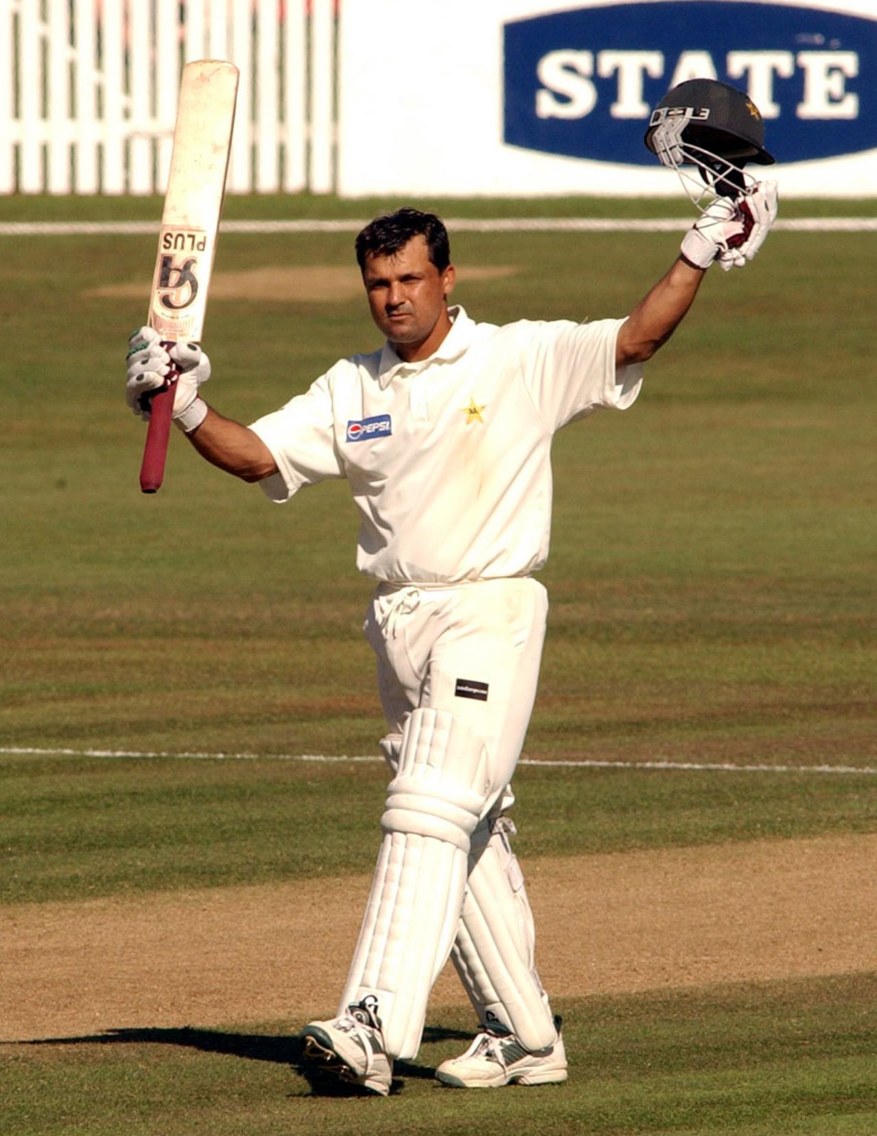 Moin Khan raises his bat after reaching his century, New Zealand v Pakistan, 1st Test, 4th day, Hamilton, December 22, 2003