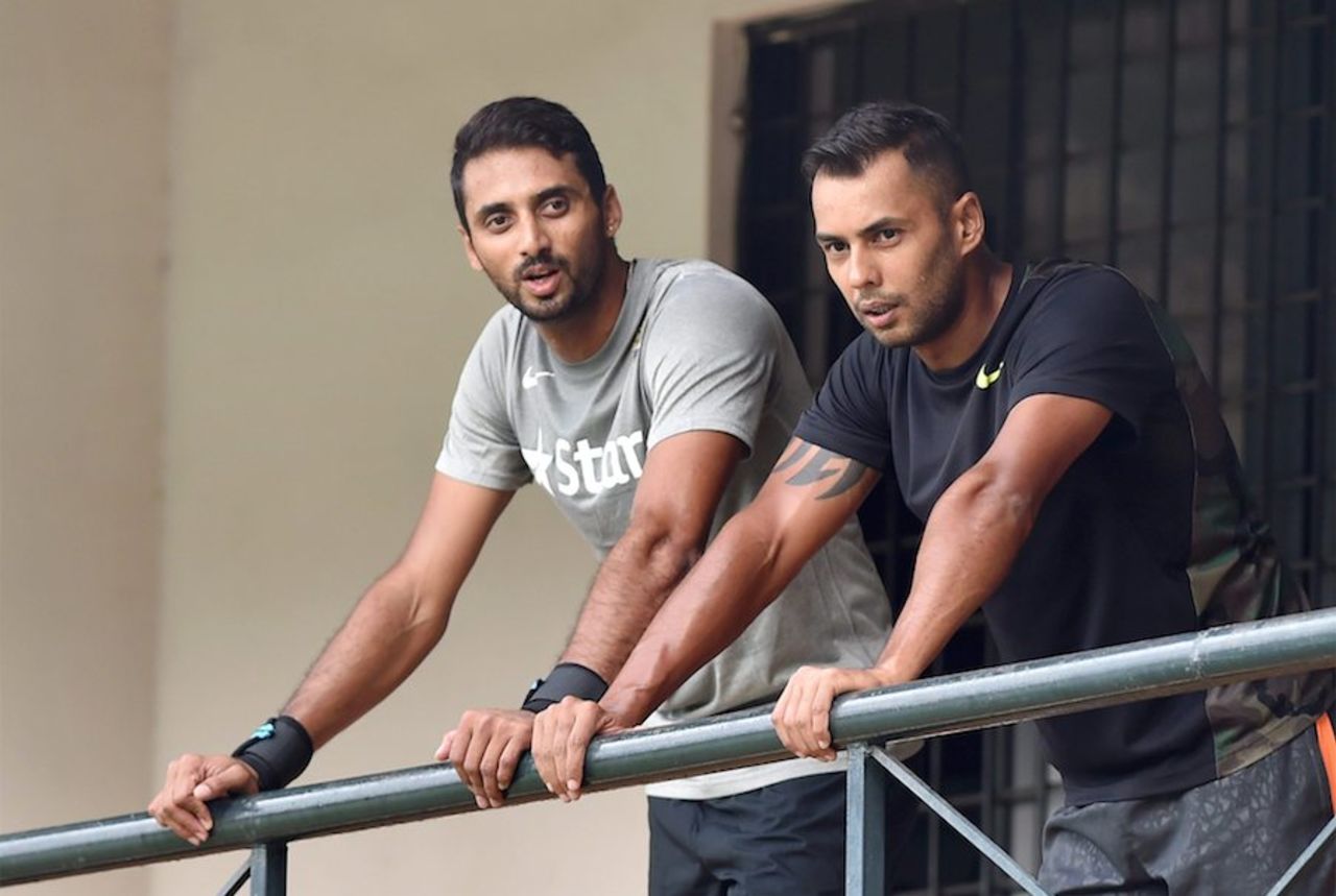 Karnataka team-mates S Aravind and Stuart Binny look on from the balcony, Bangalore, September 23, 2015