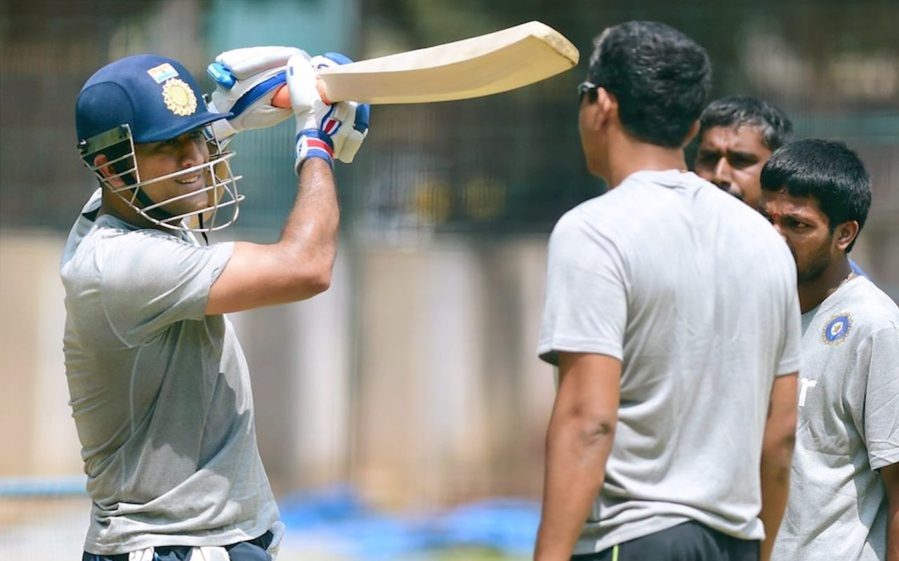 MS Dhoni has a chat with Sanjay Bangar during the preparatory camp, Bangalore, September 23, 2015