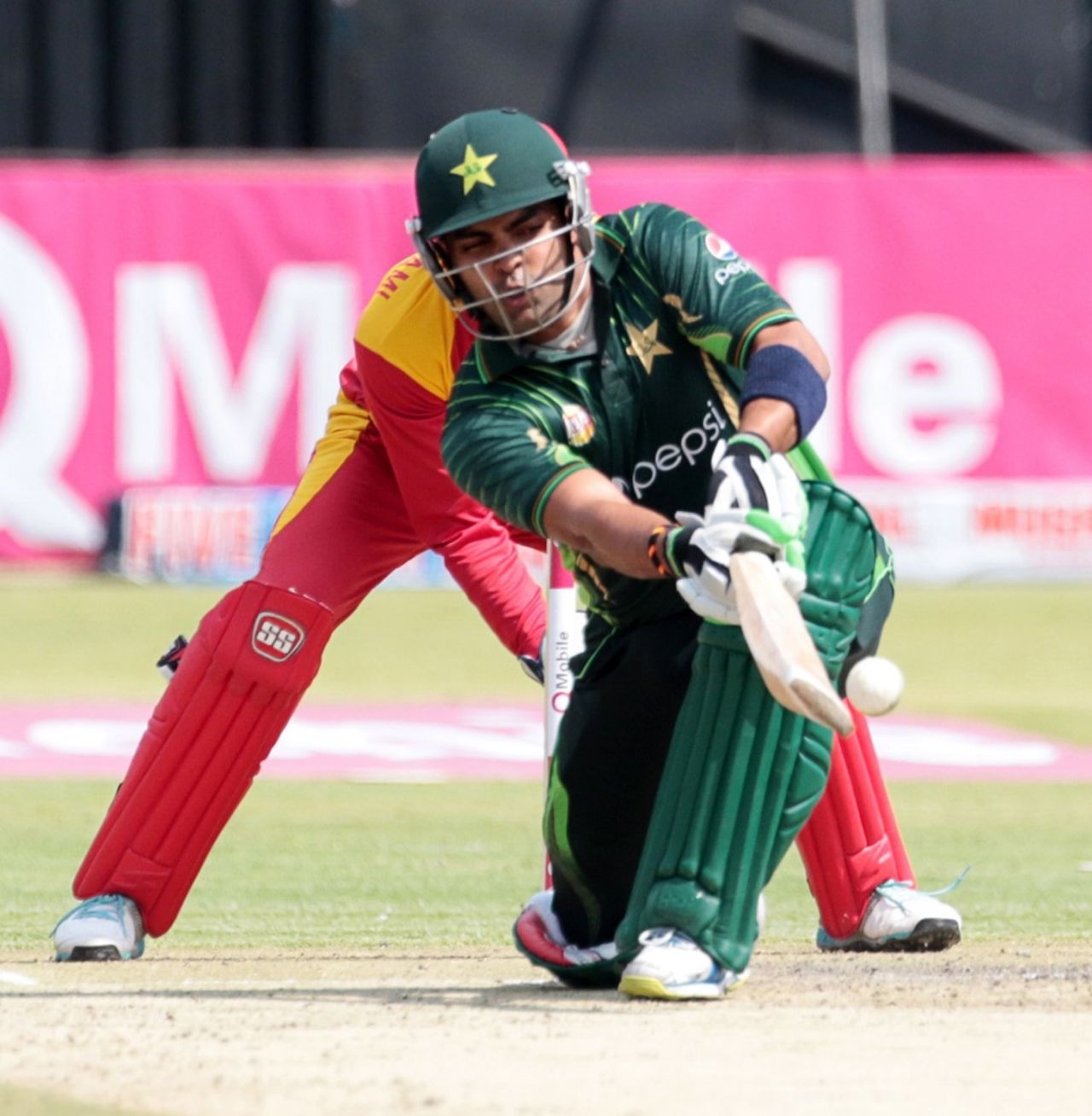 Umar Akmal goes low for a sweep, Zimbabwe v Pakistan, 1st T20, Harare, September 27, 2015