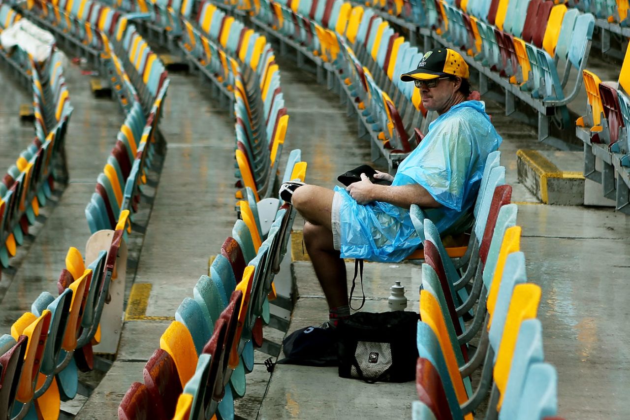 A spectator sits in the stands as rain continues to delay play, Australia v South Africa, 1st Test, Brisbane, 2nd day, November 10, 2012