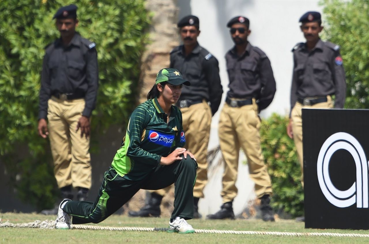 Aliya Riaz stretches with security personnel in the background, Pakistan v Bangladesh, 1st women's T20, Karachi, September 30, 2015