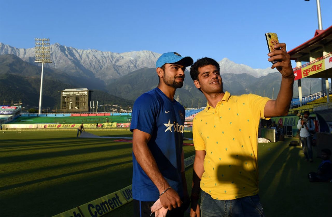 Virat Kohli obliges a fan after a net session on the eve of the first T20I against South Africa, Dharamsala, October 1, 2015