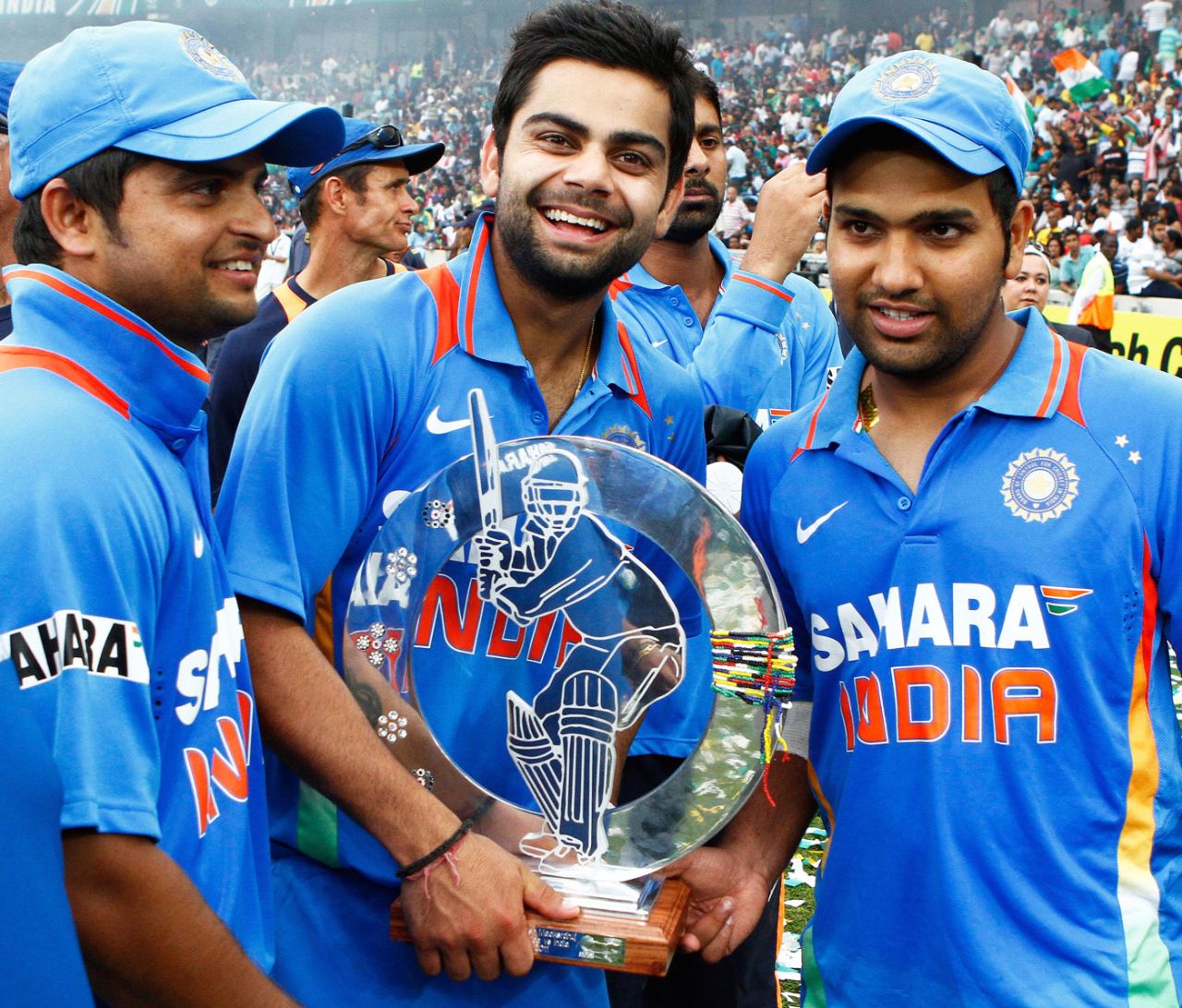 Suresh Raina, Virat Kohli and Rohit Sharma pose with the trophy after winning the one-off Twenty20 international, South Africa v India, only Twenty20, Durban