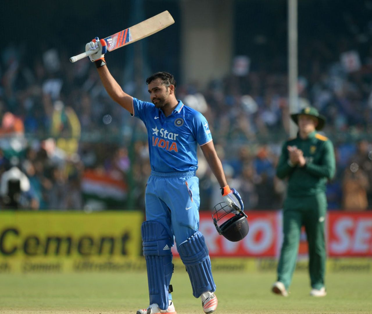 Rohit Sharma raises his bat after completing his eighth ODI century, India v South Africa, 1st ODI, Kanpur, October 11, 2015