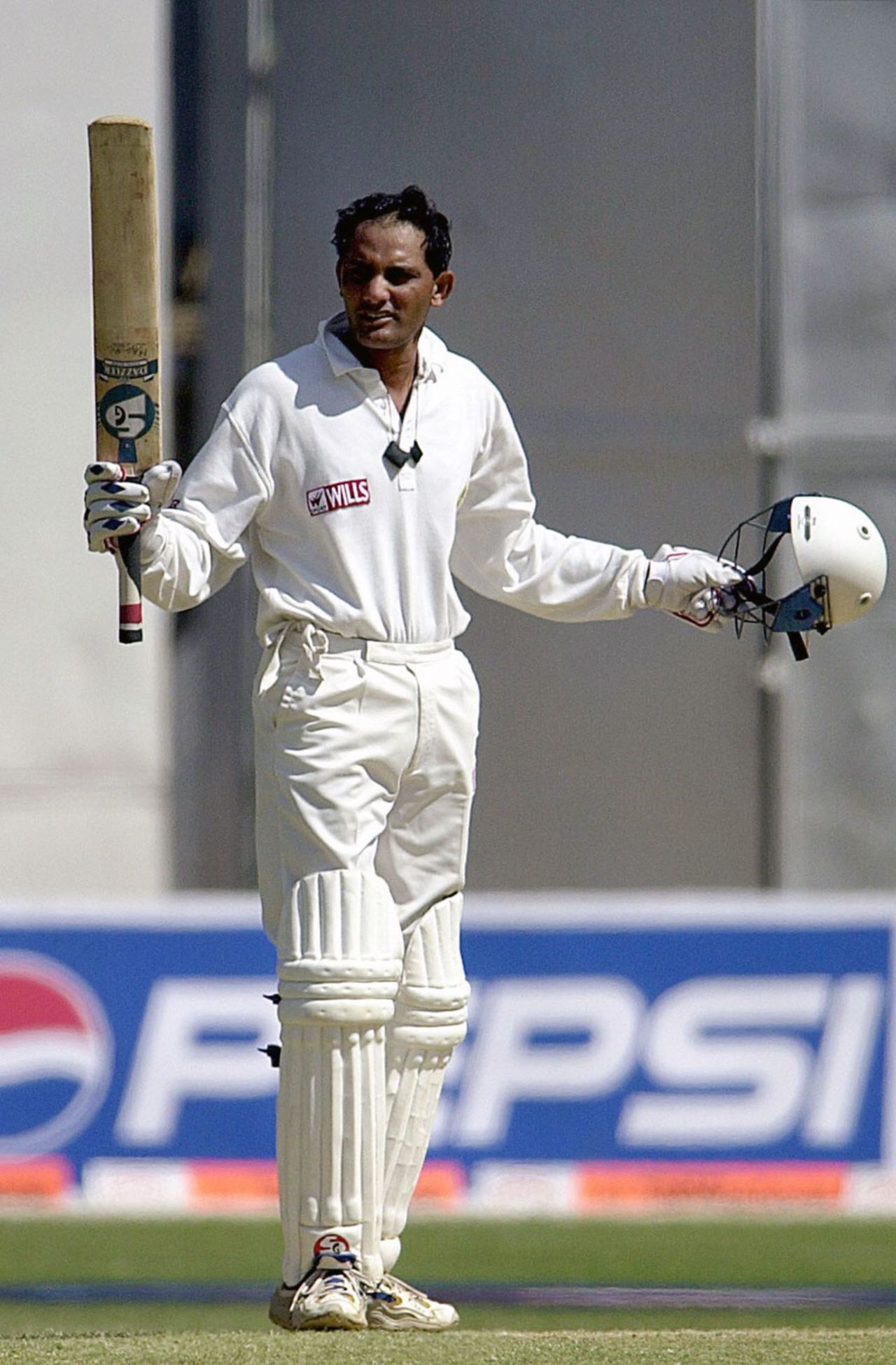 Mohammad Azharuddin salutes the crowd after completing a century, India v South Africa, second Test, Bangalore, 5th day, March 6, 2000
