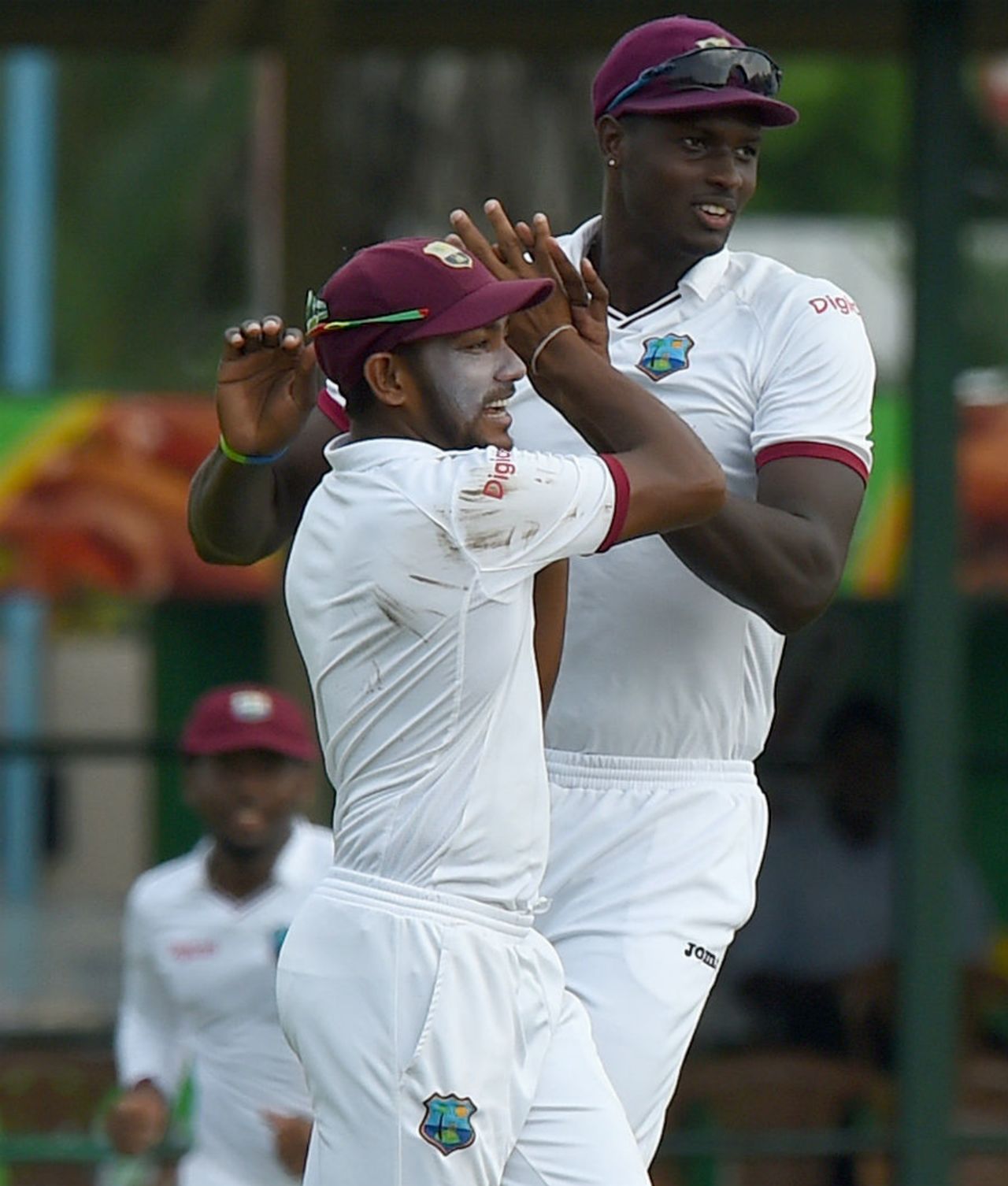 Devendra Bishoo and Jason Holder celebrate the wicket of Dimuth Karunaratne, Sri Lanka v West Indies, 2nd Test, Colombo, 2nd day, October 23, 2015