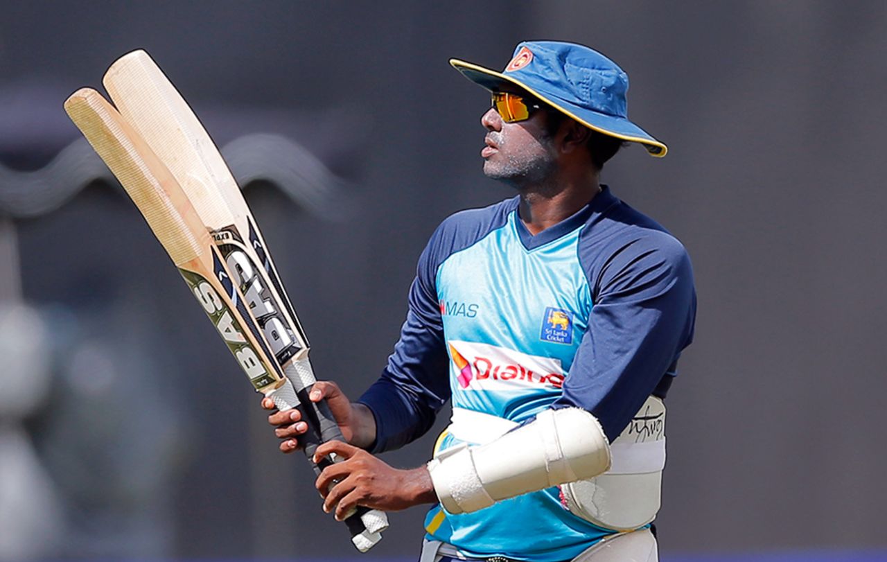 The two-bat trick: Angelo Mathews examines his bats during a training session, Colombo, October 31, 2015