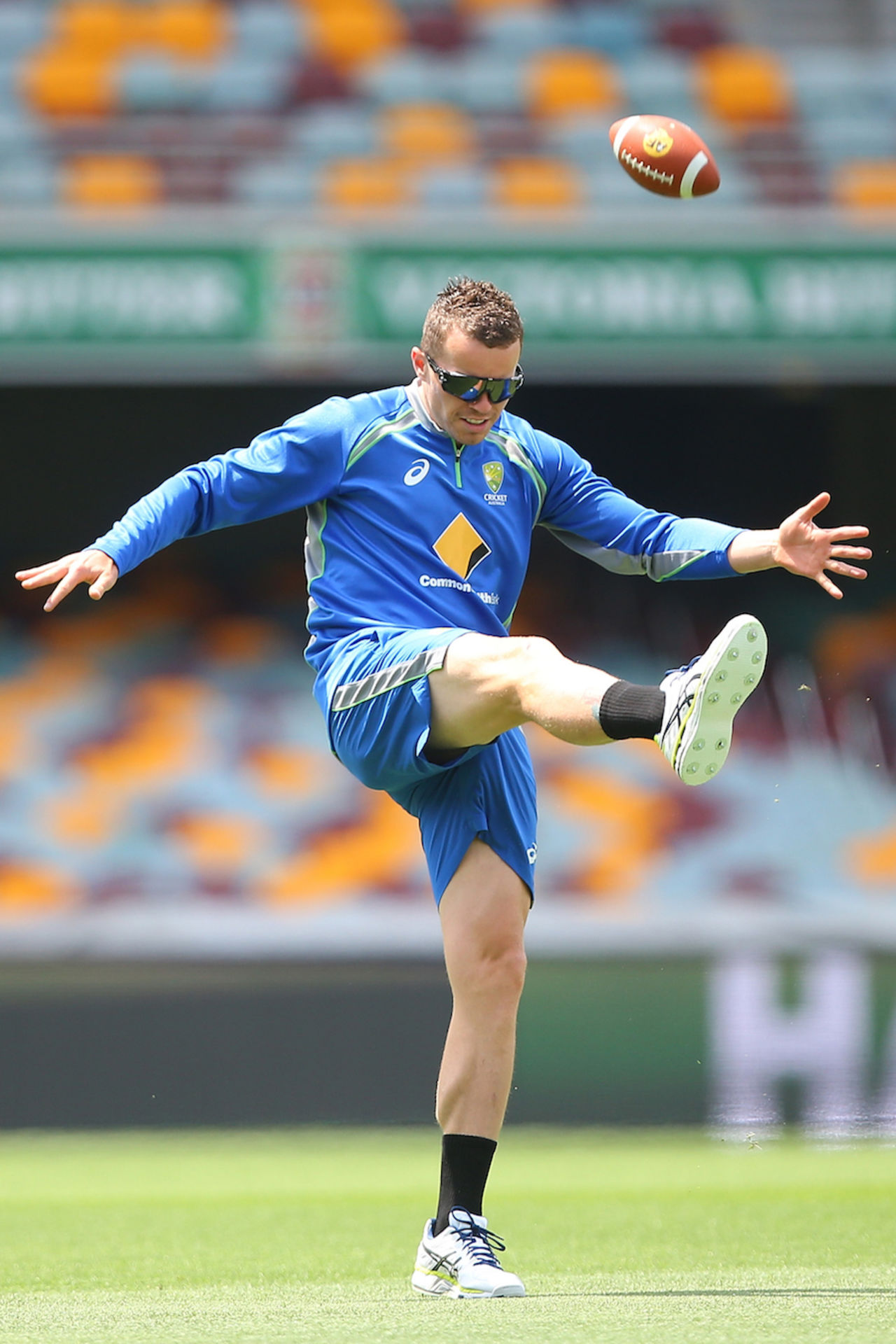 Peter Siddle kicks a football around during a practice session , Brisbane, November 4, 2015