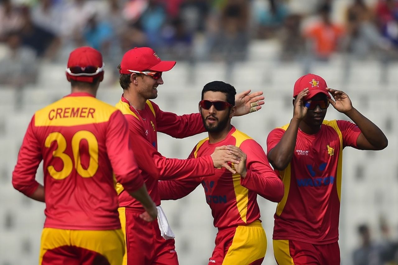 Sikandar Raza is mobbed by his team-mates,  Bangladesh v Zimbabwe, 1st ODI, Mirpur, November 7, 2015