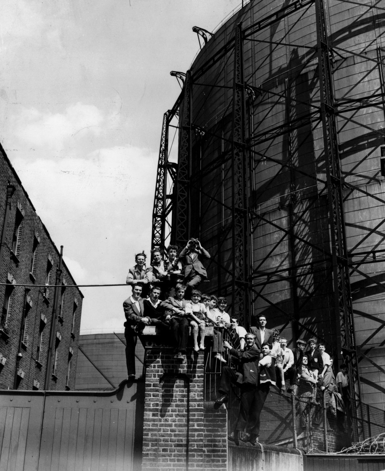 Children and adults get a vantage point from where to watch the proceedings of the Oval Test, England v Australia, 5th Test, The Oval, 2nd day, August 17, 1953