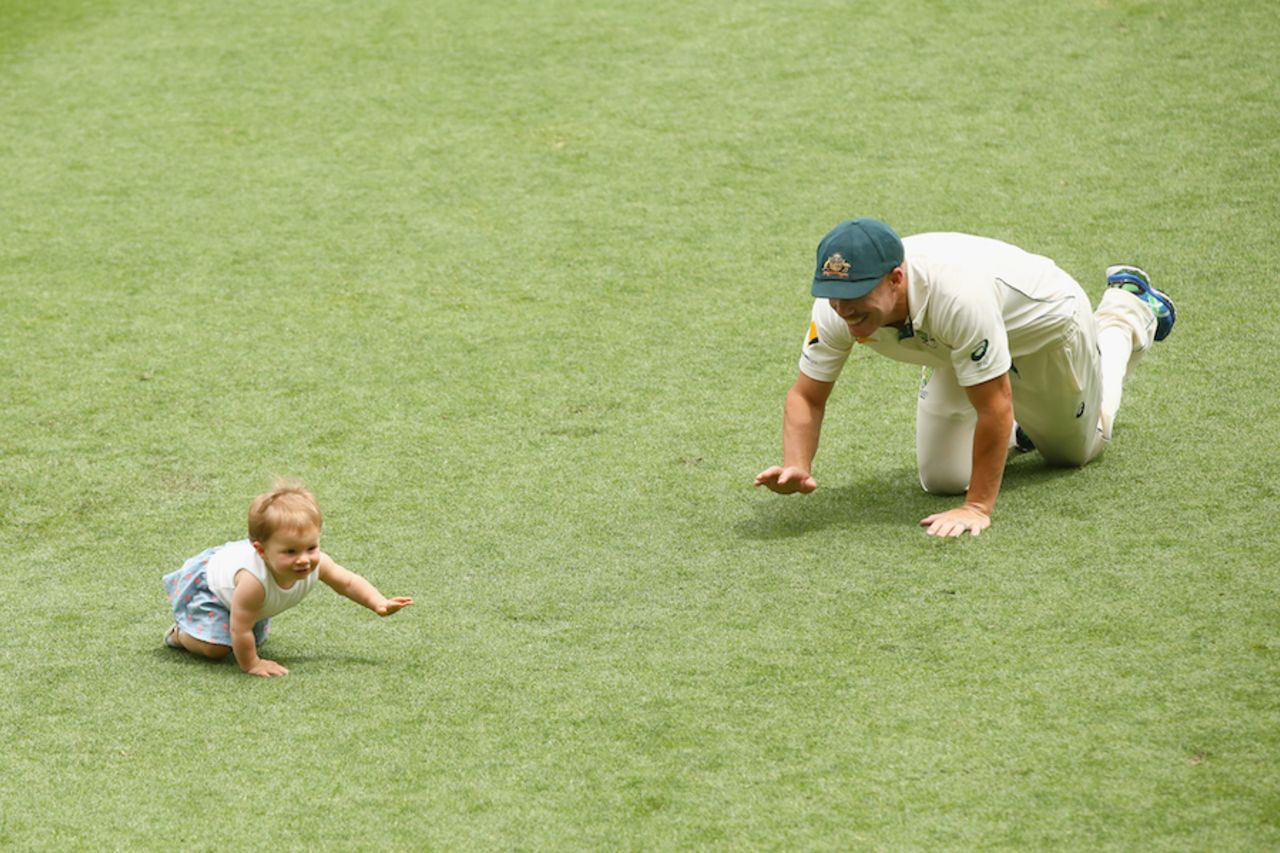 David Warner crawls around with his daughter after the win, Australia v New Zealand, 1st Test, Brisbane, 5th day, November 9, 2015