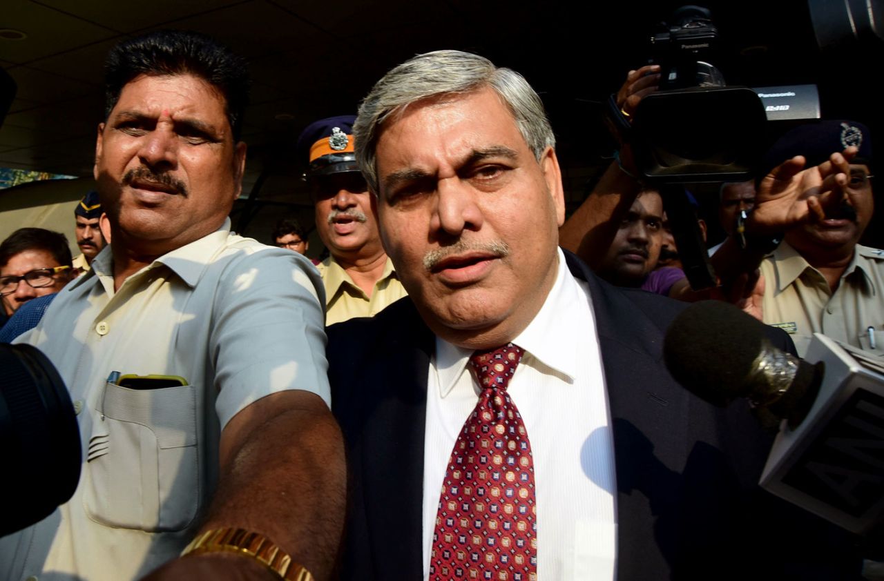 The BCCI  president Shashank Manohar is escorted out of the board's headquarters at the Wankhede stadium in Mumbai , October 19, 2015