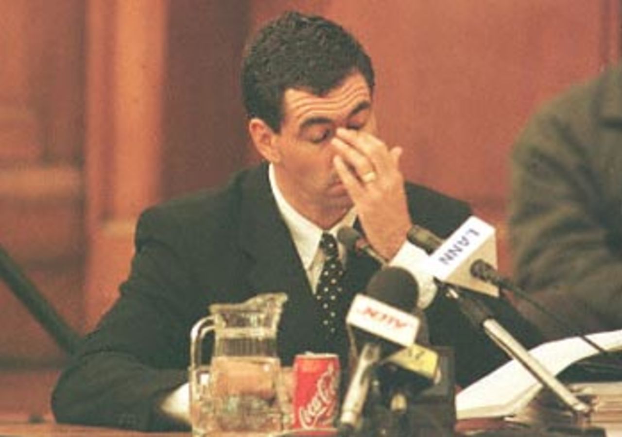 Former South African cricket captain Hansie Cronje wipes his eye during his cross-examination at the King Commission of Inquiry into allegations of cricket match-fixing in Cape Town 21June 2000.