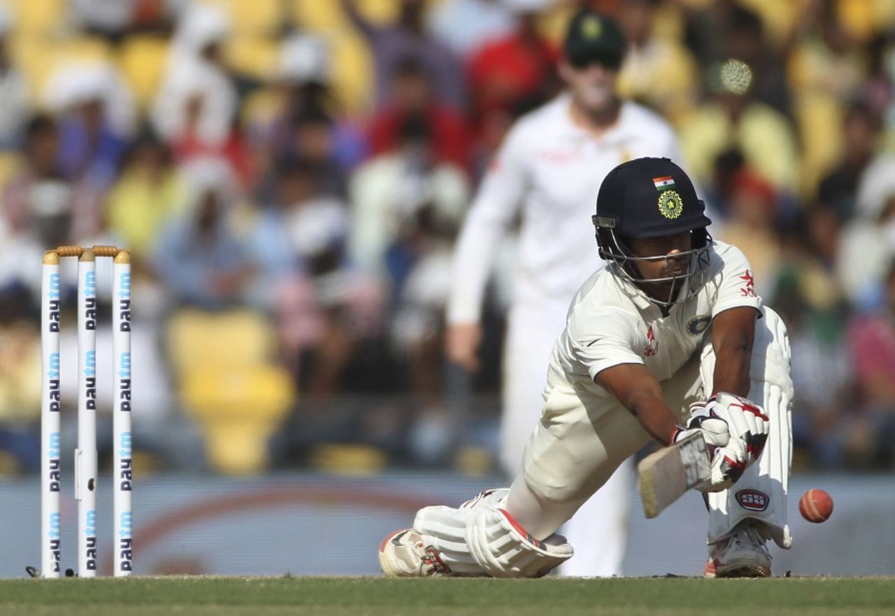 Wriddhiman Saha gets down to play a sweep, 3rd Test, Nagpur, 2nd day, November 26, 2015