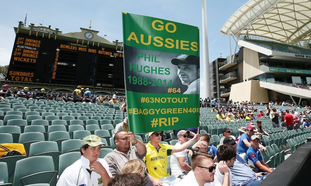 A fan holds up a tribute to Phillip Hughes on the first anniversary of his death, Australia v New Zealand, 3rd Test, Adelaide, November 27, 2015