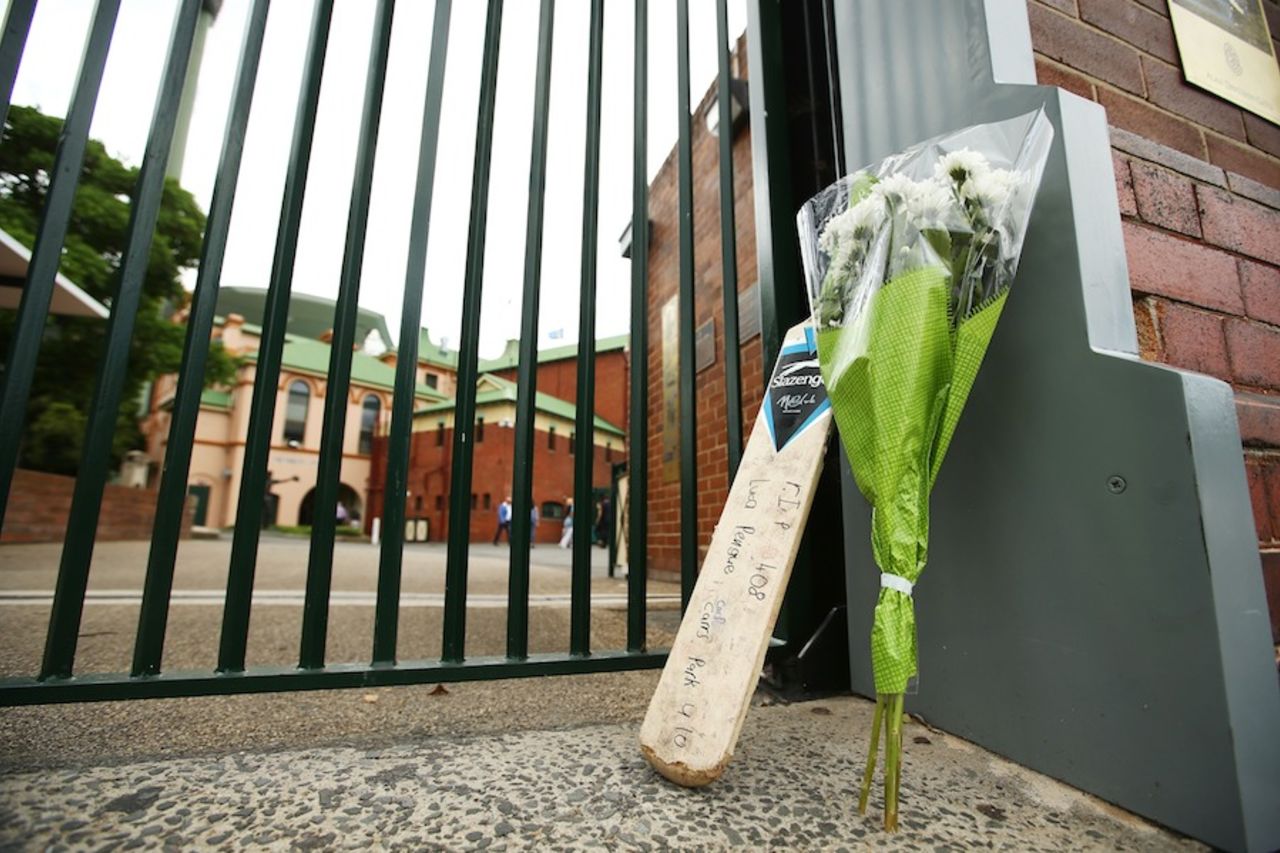A bat and a bouquet left outside the SCG in tribute to Phillip Hughes, Sydney, November 27, 2015
