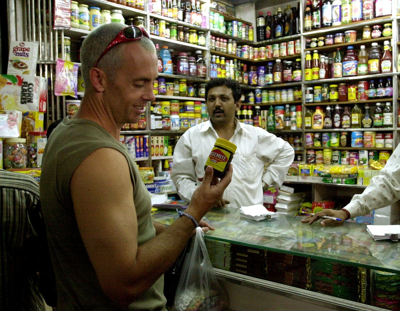Colin Miller inspects a bottle of Vegemite in a shop in Mumbai, February 21, 2001