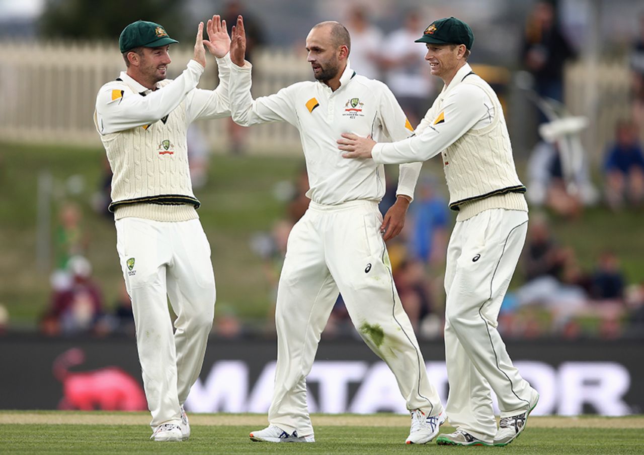Nathan Lyon celebrates a wicket with Shaun Marsh and Adam Voges, Australia v West Indies, 1st Test, Hobart, 2nd day, December 11, 2015