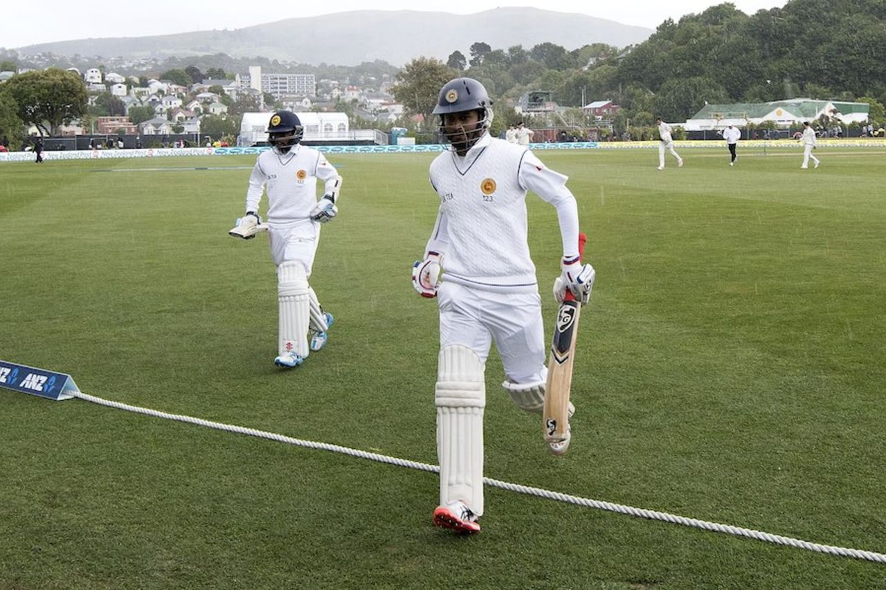 Dimuth Karunaratne and Kusal Mendis jog off the field in the rain, New Zealand v Sri Lanka, 1st Test, Dunedin, 4th day, December 13, 2015
