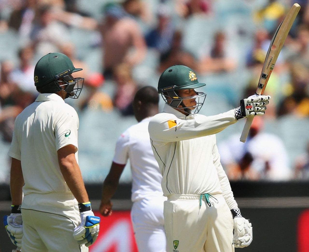 Usman Khawaja raises his bat after completing his fifty , Australia v West Indies, 2nd Test, 1st day, Melbourne, December 26, 2015