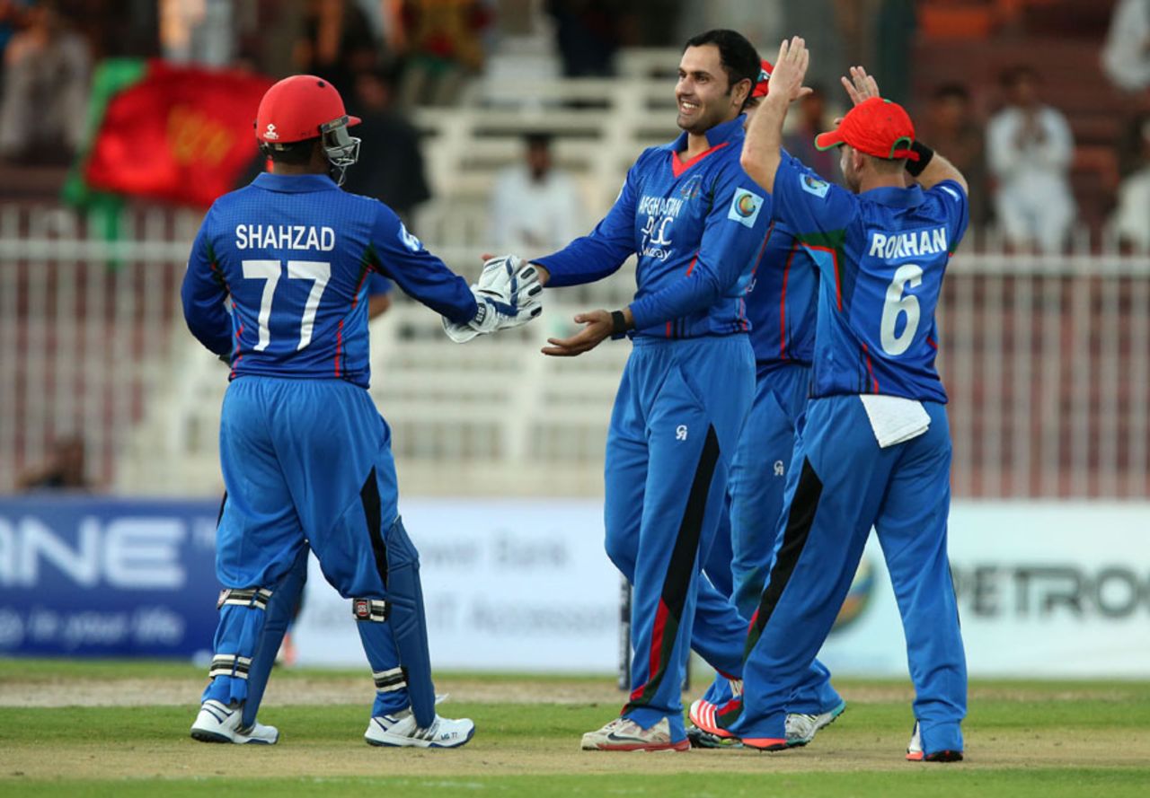 Mohammad Nabi celebrates a wicket with teammates, Afghanistan v Zimbabwe, 2nd ODI, Sharjah, December 29, 2015