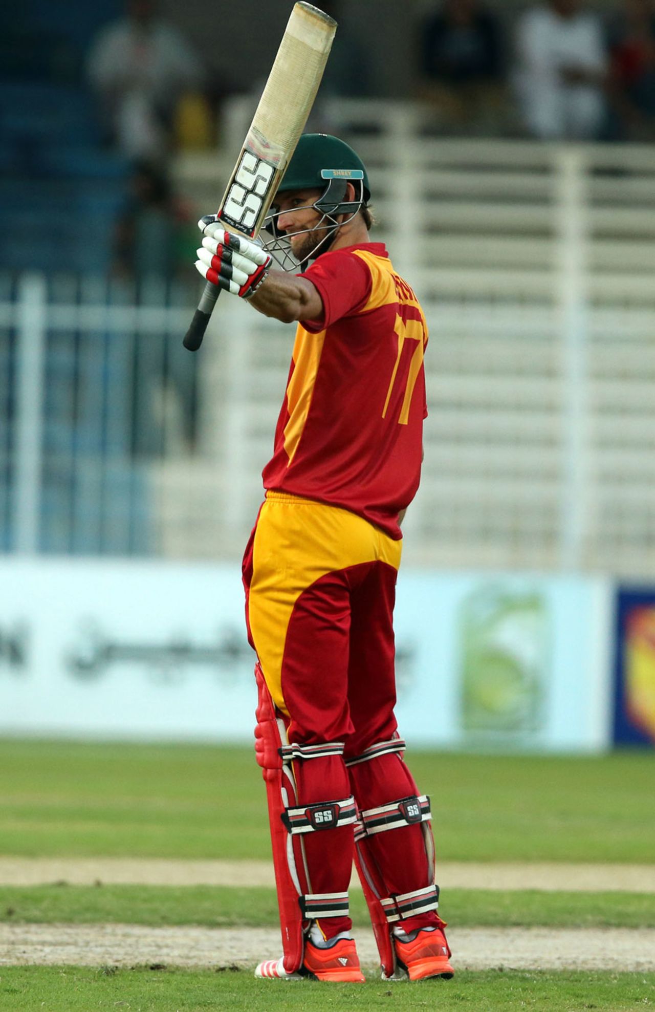 Craig Ervine raises his bat after completing his fifty, Afghanistan v Zimbabwe, 2nd ODI, Sharjah, December 29, 2015