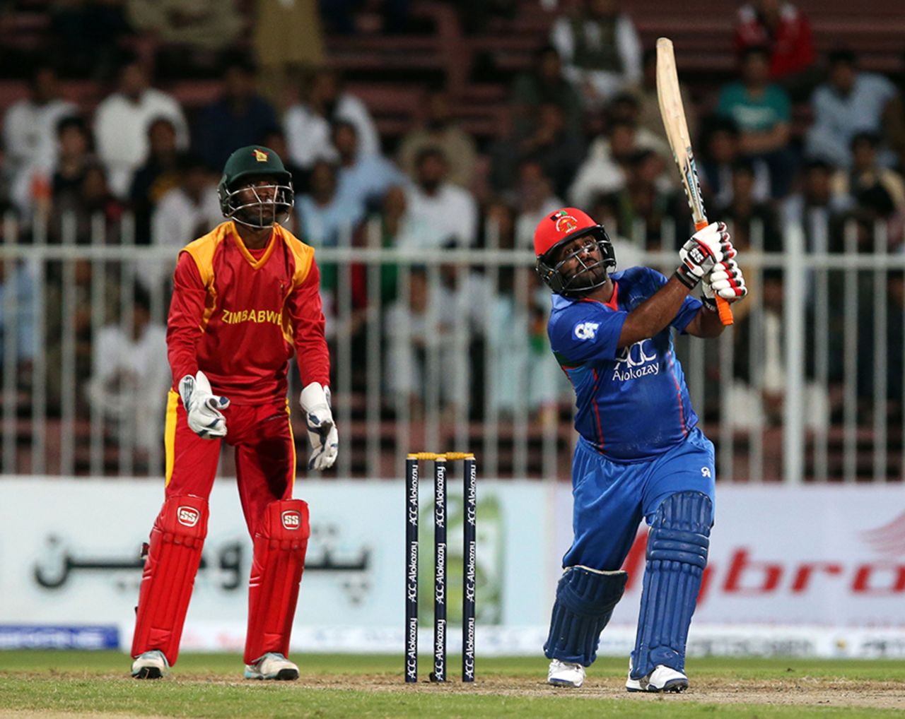 Mohammad Shahzad plays a lofted shot down the ground, Afghanistan v Zimbabwe, 2nd ODI, Sharjah, December 29, 2015