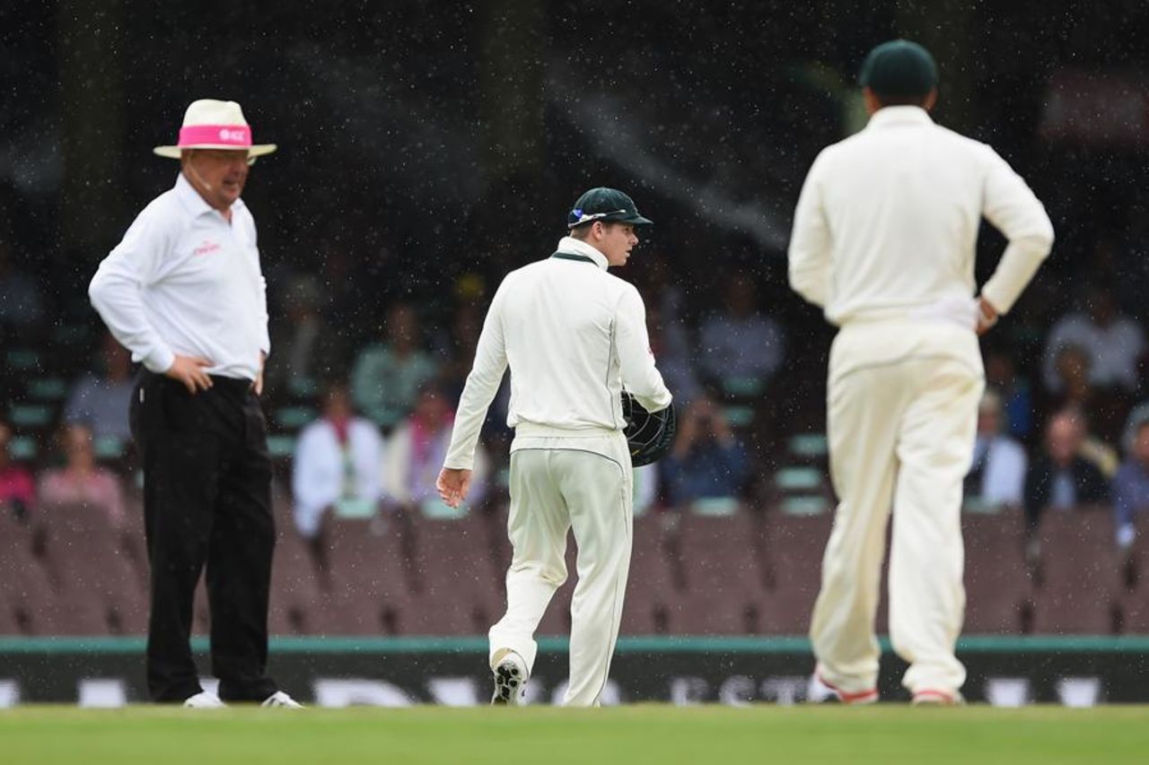 Steven Smith and Ian Gould watch the rain fall, Australia v West Indies, 3rd Test, Sydney, 2nd day, January 4, 2016