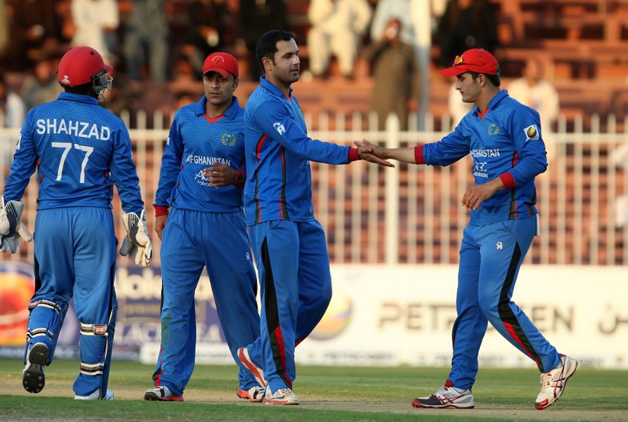 Mohammad Nabi celebrates a wicket with his team-mates, Afghanistan v Zimbabwe, 5th ODI, Sharjah, January 6, 2016