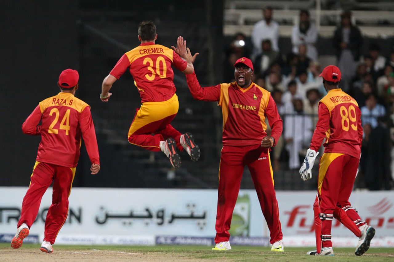 A jubilant Graeme Cremer is greeted with a high five, Afghanistan v Zimbabwe, 5th ODI, Sharjah, January 6, 2016