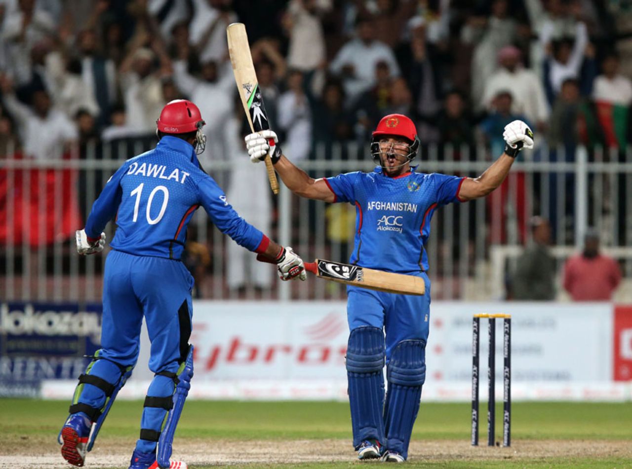 Gulbadin Naib and Dawlat Zadran celebrate Afghanistan's historic win, Afghanistan v Zimbabwe, 5th ODI, Sharjah, January 6, 2016