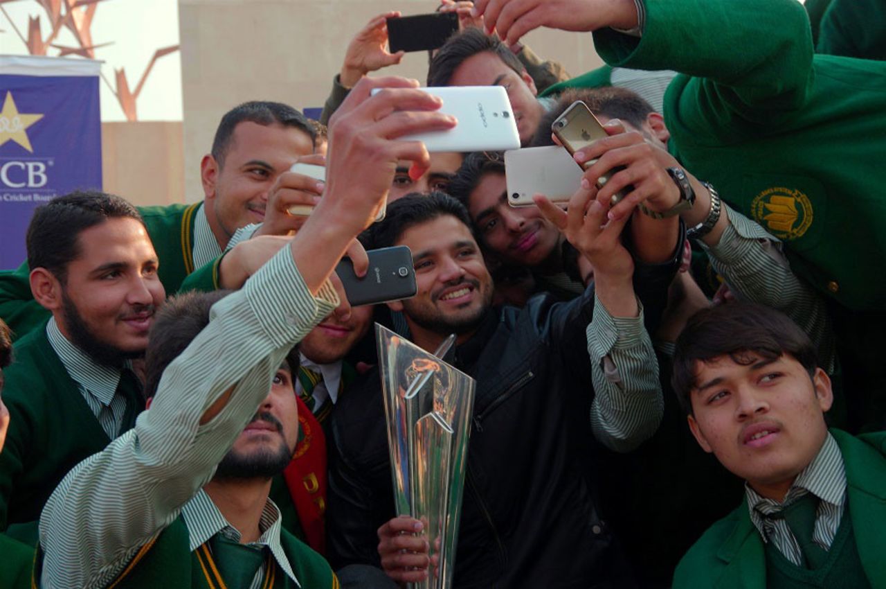 Students of the Army Public School take selfies with Azhar Ali and the World T20 trophy, Peshawar, January 11, 2015