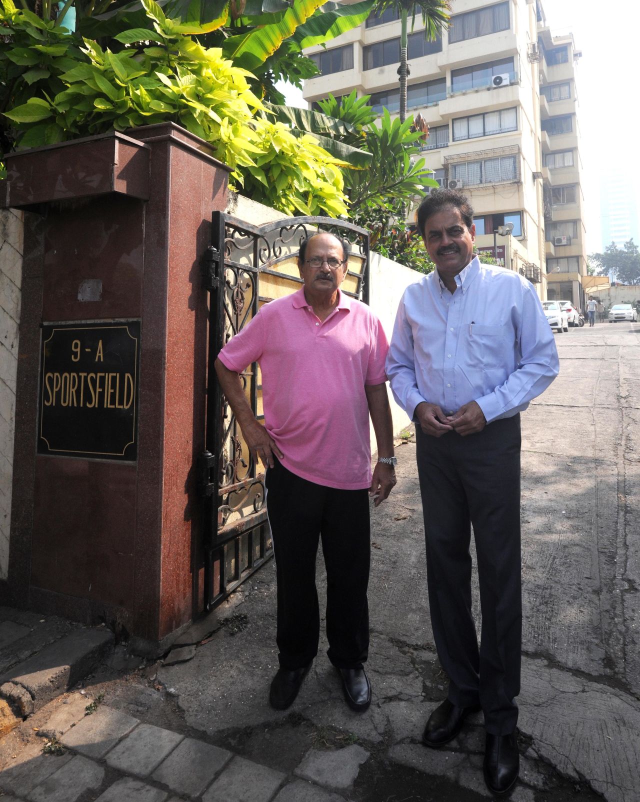 Ajit Wadekar and Dilip Vengsarkar stand outside their apartment building, Sportsfield, in Worli, Mumbai, January 13, 2016