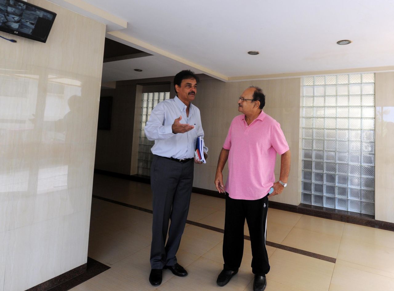 Ajit Wadekar and Dilip Vengsarkar stand inside the lobby of their apartment building, Sportsfield, in Worli, Mumbai, January 13, 2016