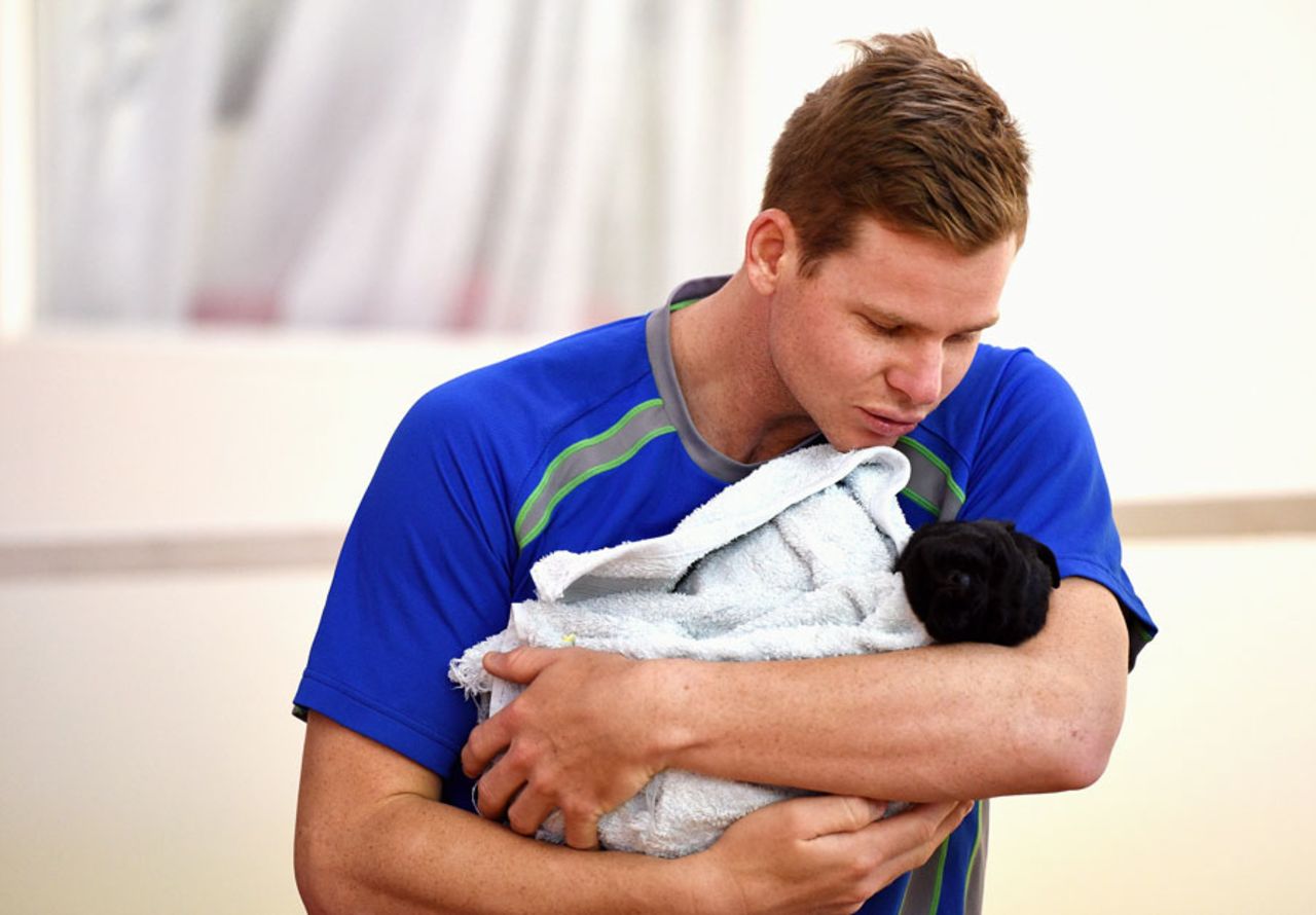 Steven Smith interacts with a puppy guide dog, Adelaide, January 25, 2016