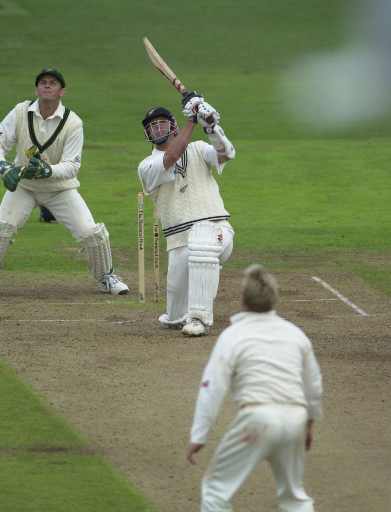 Chris Cairns hits a six as Shane Warne and Adam Gilchrist look on, New Zealand v Australia, second Test, day three, Wellington, March 26, 2000


