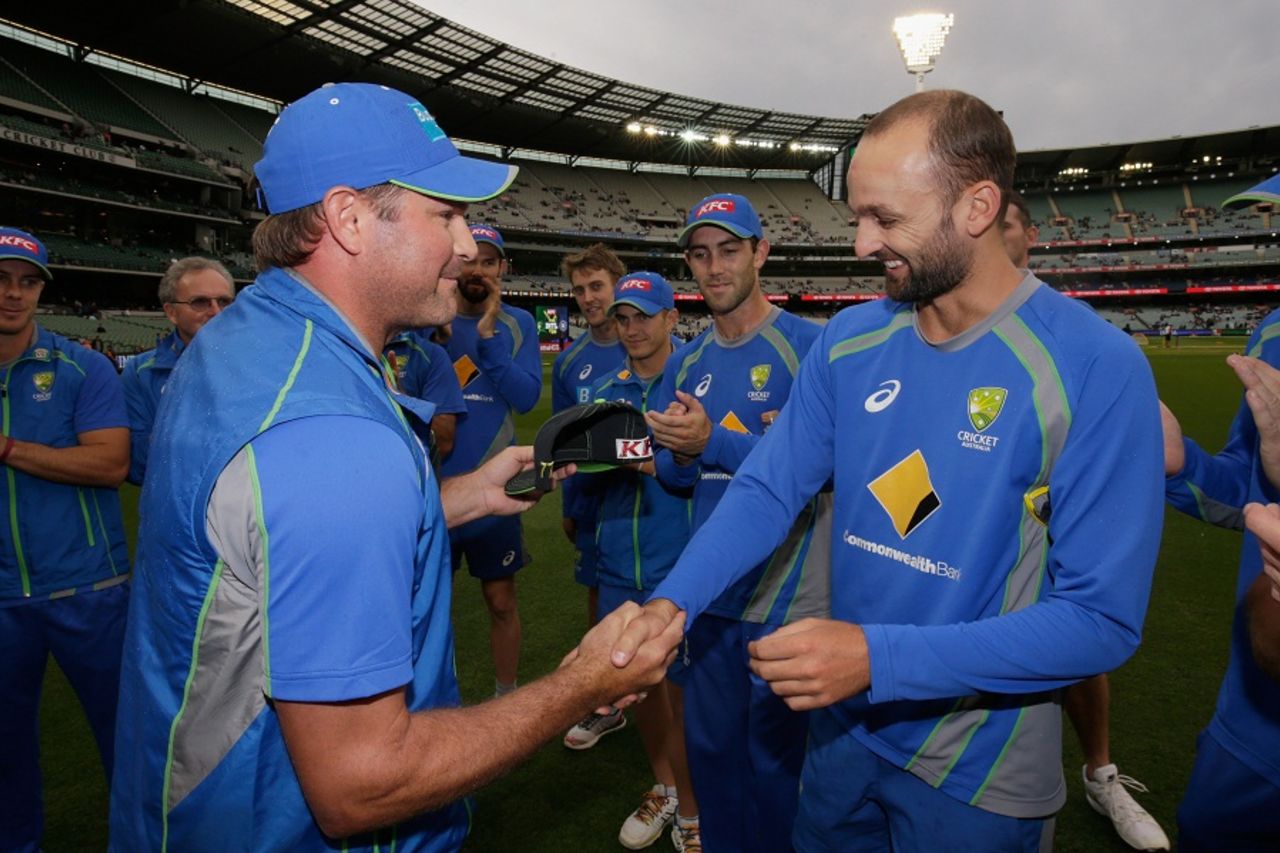 Nathan Lyon is handed his Australia T20I cap by Ryan Harris, Australia v India, 2nd T20I, Melbourne, January 29, 2016