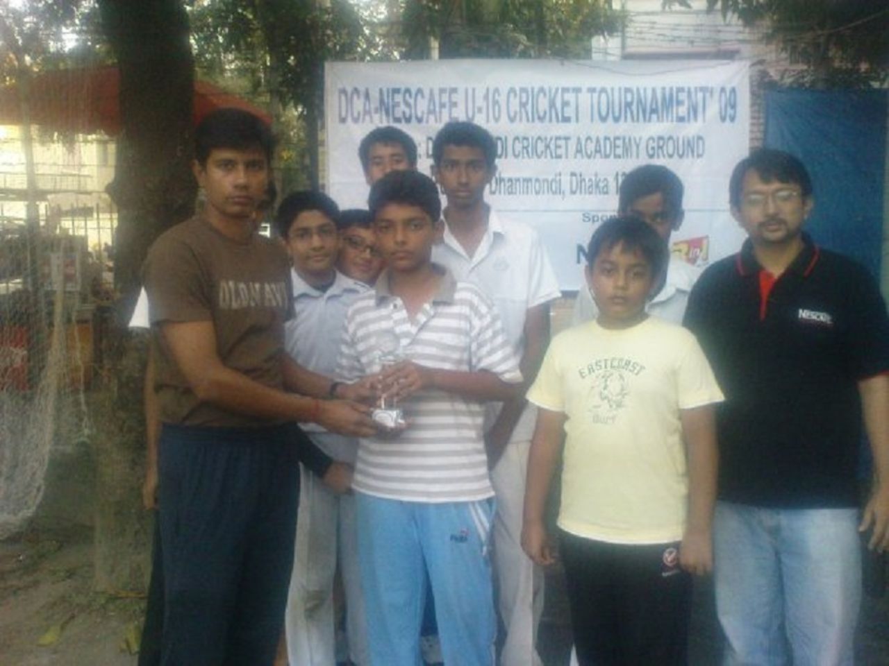 Saif Hassan (centre) receives a trophy at the Dhanmondi Cricket Academy, 2009