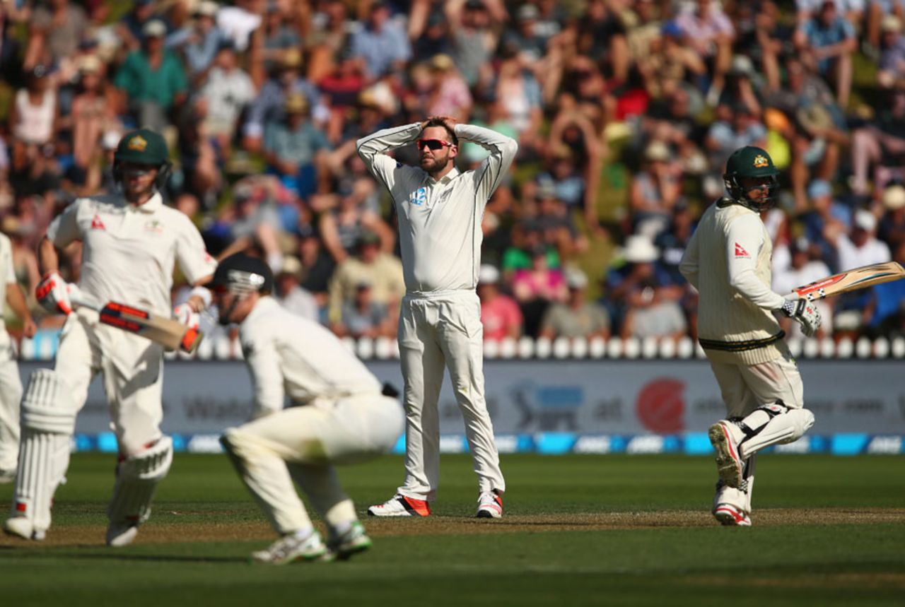 Mark Craig reacts to a chance as Steven Smith and Usman Khawaja complete a run, New Zealand v Australia, 1st Test, Wellington, 1st day, February 12, 2016