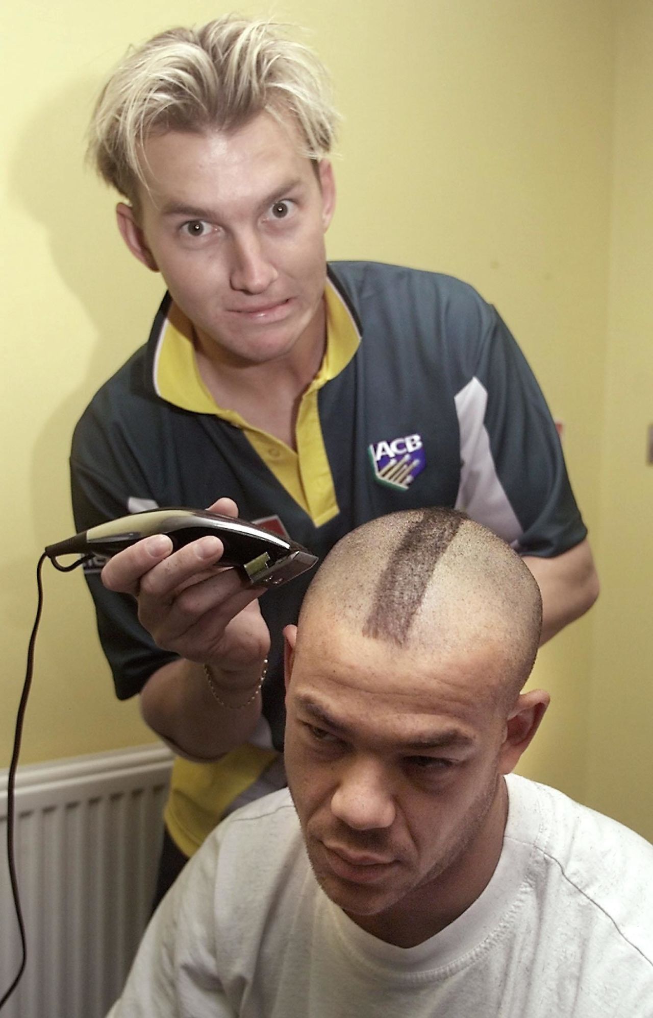 Brett Lee gives a look of apprehension to Andrew Symonds while giving him a Mohawk haircut, 6th ODI at Chester-le-Street, 16 June 2001.