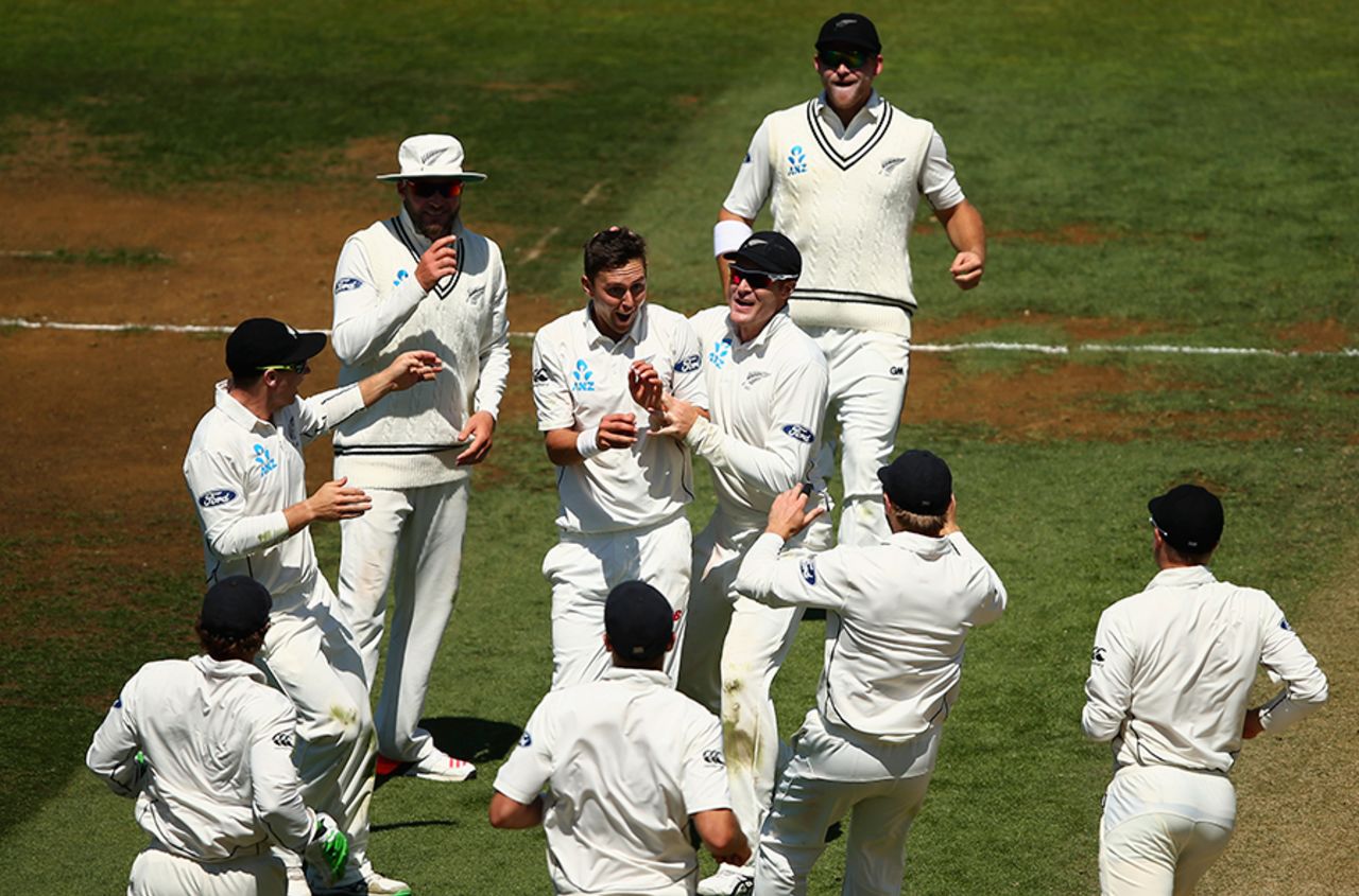 Team-mates mob Trent Boult after his stunning return catch to send back Mitchell Marsh, New Zealand v Australia, 1st Test, Wellington, 2nd day, February 13, 2016