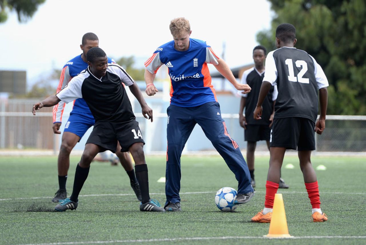 Joe Root tries to evade a tackle at a charity event in Nyanga township, Cape Town, February 15, 2016