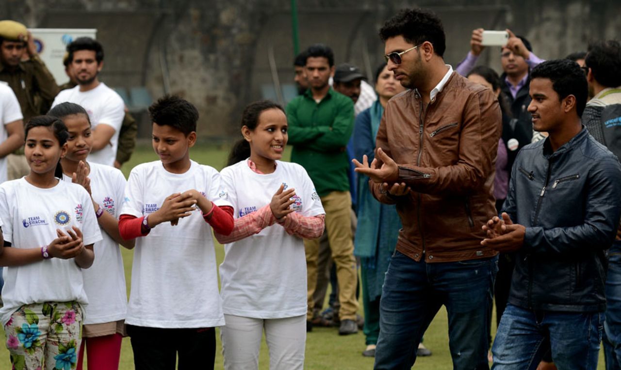 Yuvraj Singh and Pawan Negi interact with children at an event, Delhi, February 18, 2016