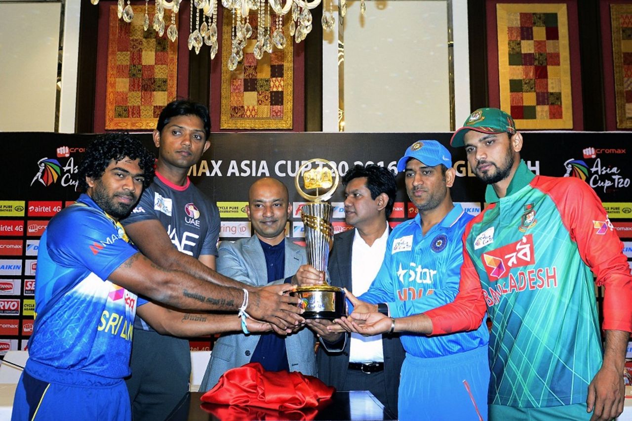 Captains Lasith Malinga, Amjad Javed, MS Dhoni and Mashrafe Mortaza pose with the Asia Cup Trophy, Dhaka, February 23, 2016