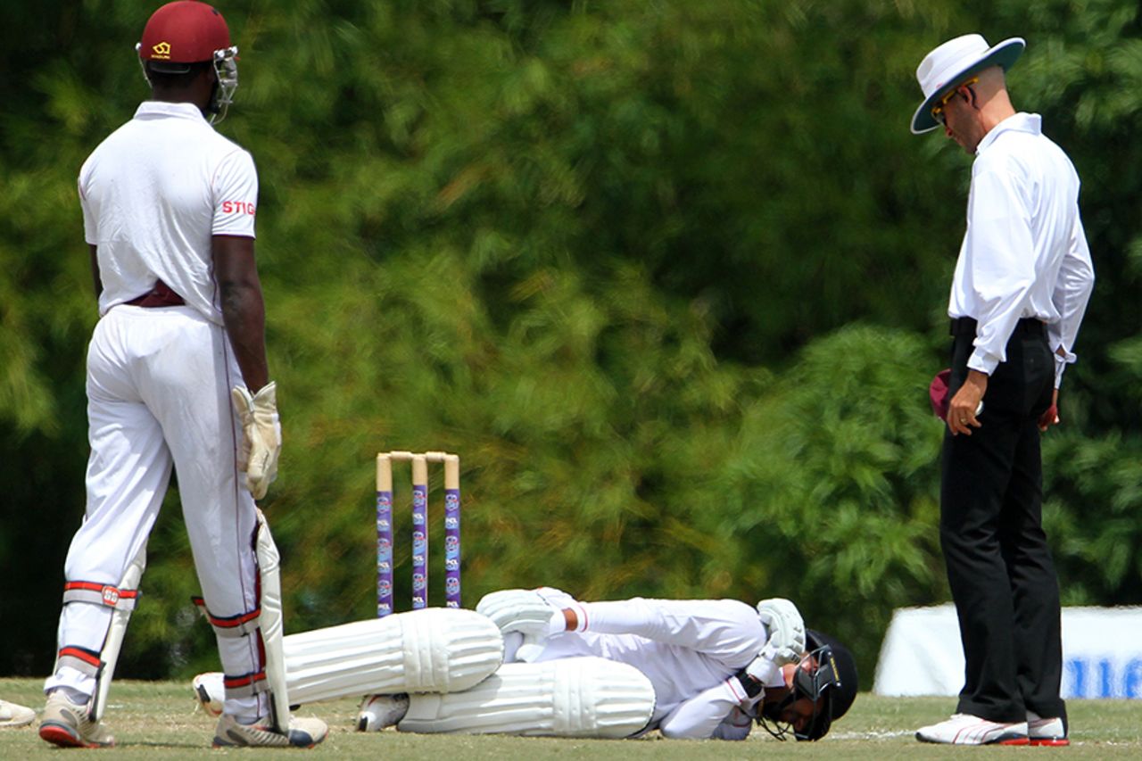 An injured Rayad Emrit lies on the ground, Trinidad & Tobago v Leeward Islands, Regional 4-Day Tournament, 3rd day, Couva, February 28, 2016