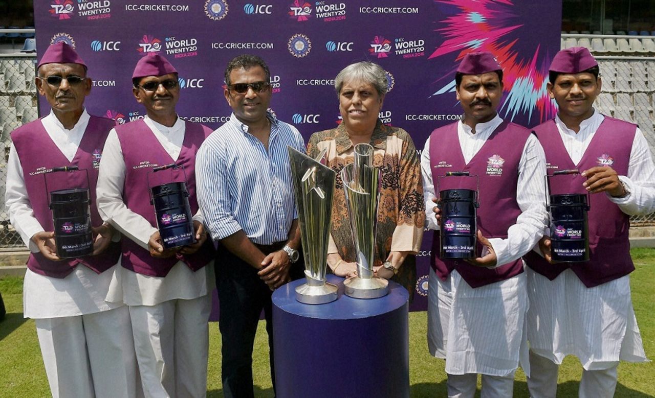 Former India cricketers Sameer Dighe and Diana Edulji  and Mumbai dabbawalas pose with the World T20 trophies, Mumbai, March 6, 2016