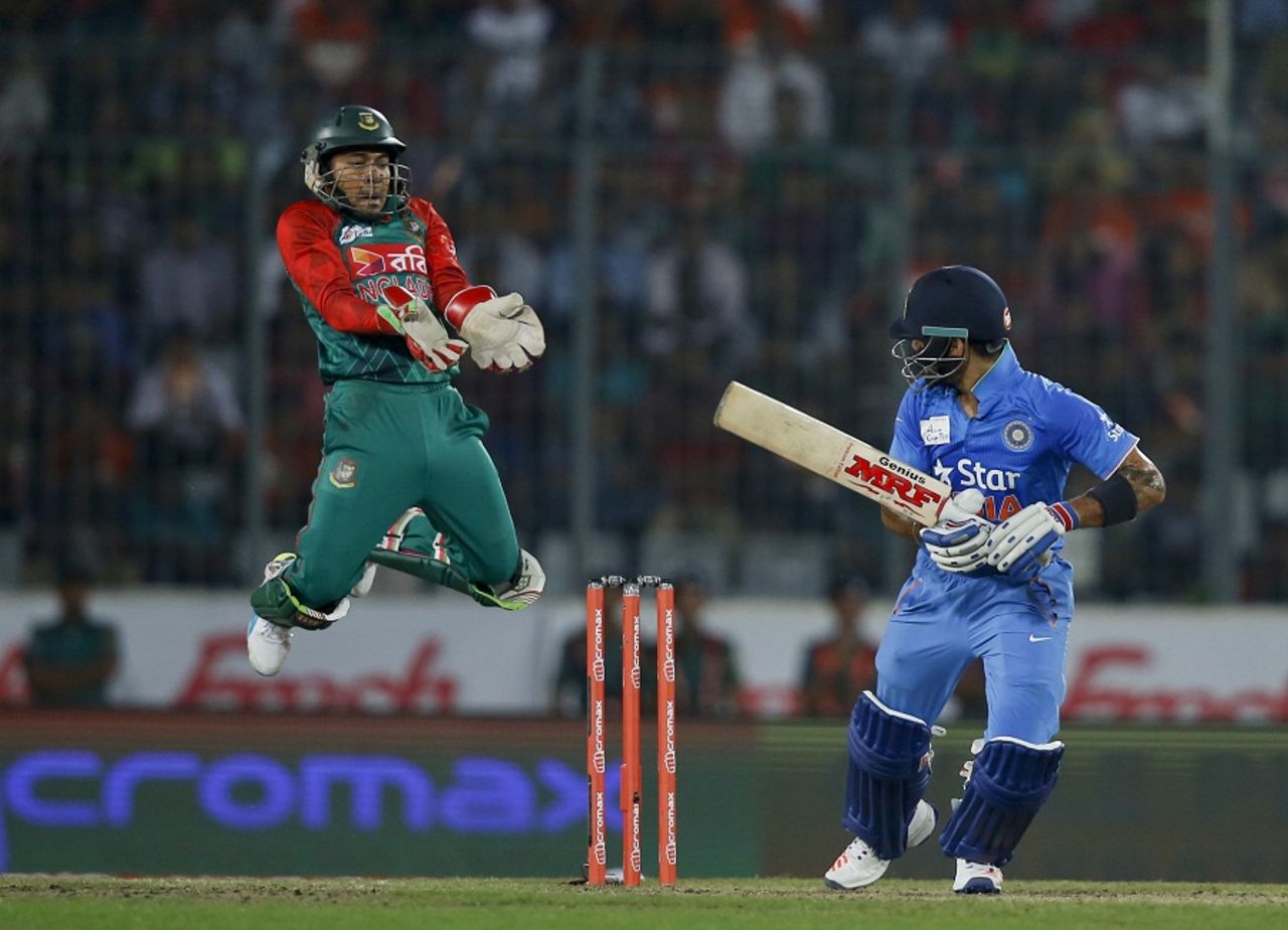 Mushfiqur Rahim leaps while Virat Kohli looks on, Bangladesh v India, Asia Cup final, Mirpur, March 6, 2016 